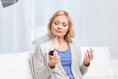 Image of woman with medicine jars at home