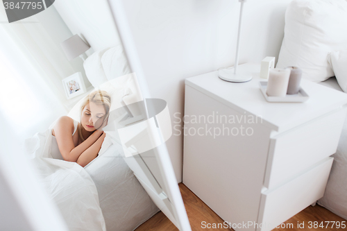 Image of young woman sleeping in bed at home bedroom