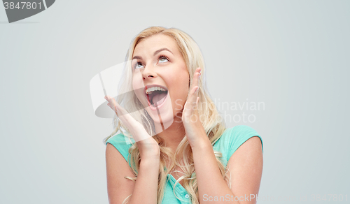 Image of surprised smiling young woman or teenage girl