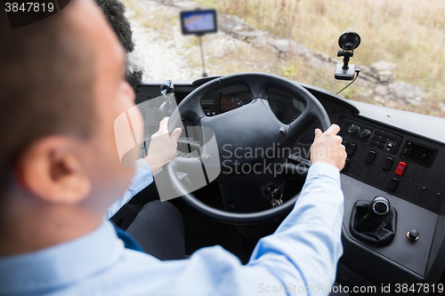 Image of close up of driver driving passenger bus