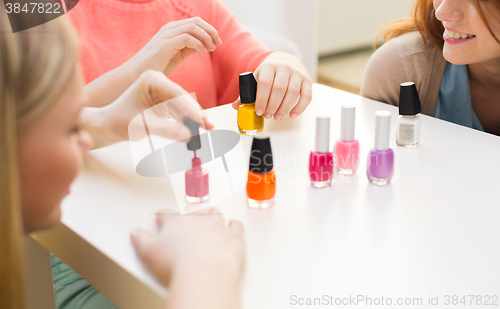 Image of close up of smiling young women with nail polish