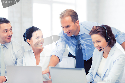 Image of group of people working in call center