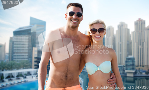 Image of happy couple in swimwear over dubai city waterside