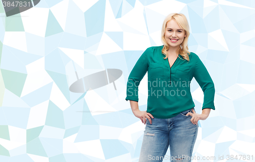 Image of smiling young woman in shirt and jeans