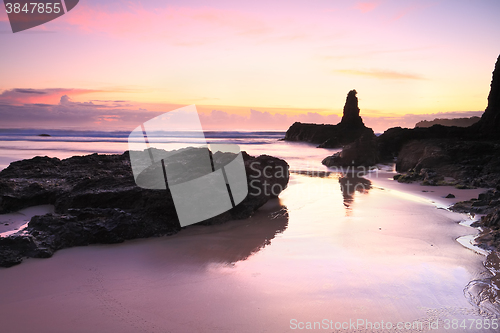 Image of Sunrise reflections in tidal wet sands Jones Beach Kiama