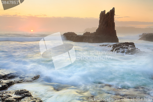Image of Sun glimpses over the horizon at Cathedral Rock Kiama