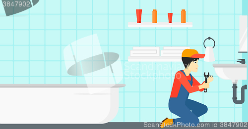 Image of Man repairing sink.