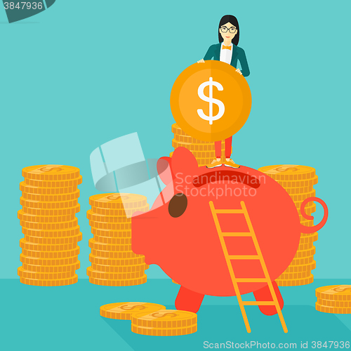 Image of Woman putting coin in piggy bank.