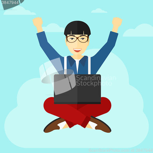 Image of Man sitting on cloud with laptop.