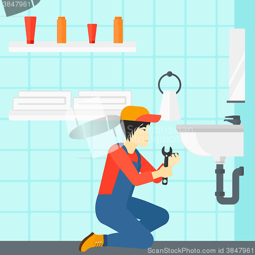 Image of Man repairing sink.