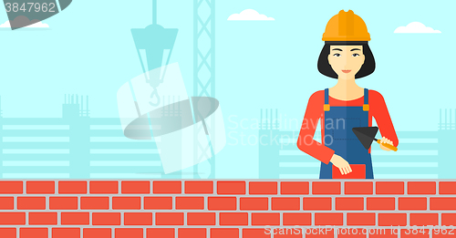 Image of Bricklayer with spatula and brick.