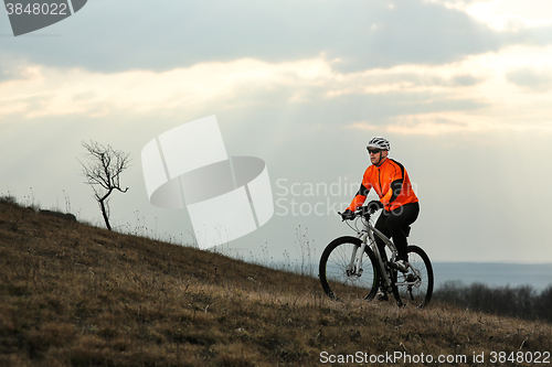 Image of Man cyclist with backpack riding the bicycle