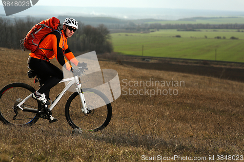 Image of Man cyclist with backpack riding the bicycle