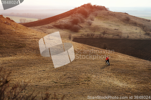 Image of Man cyclist with backpack riding the bicycle