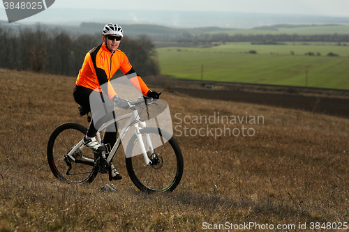 Image of Man cyclist with backpack riding the bicycle