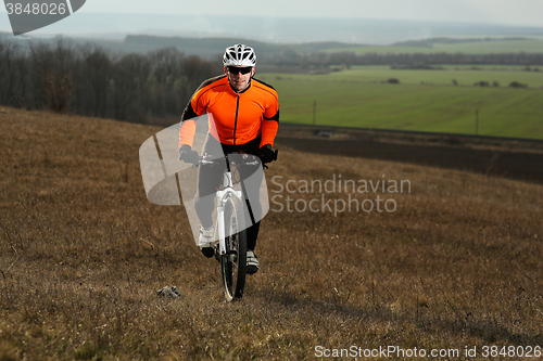 Image of Man cyclist with backpack riding the bicycle