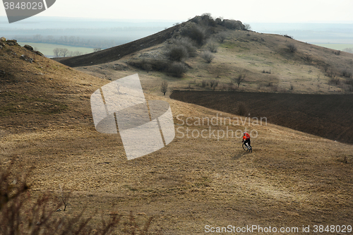 Image of Man cyclist with backpack riding the bicycle