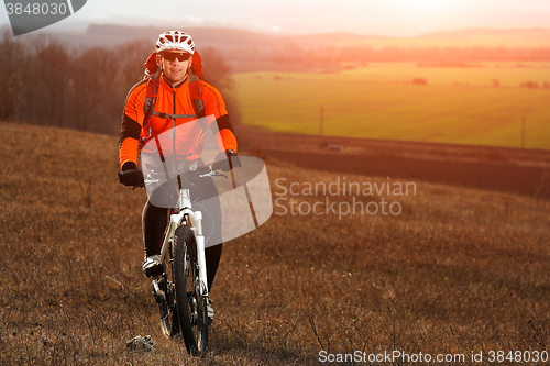 Image of Man cyclist with backpack riding the bicycle