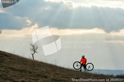 Image of Man cyclist with backpack riding the bicycle