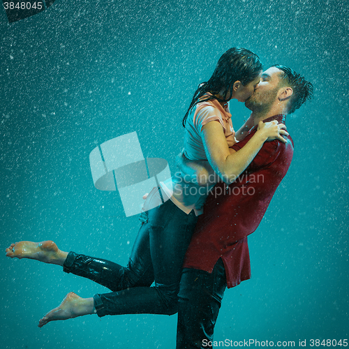 Image of The loving couple in the rain