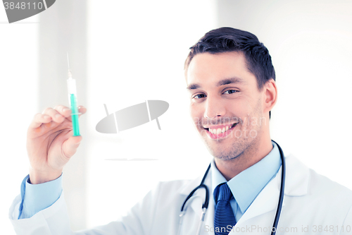 Image of male doctor holding syringe with injection