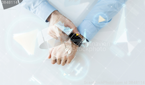 Image of hand with smartwatch and virtual screen projection