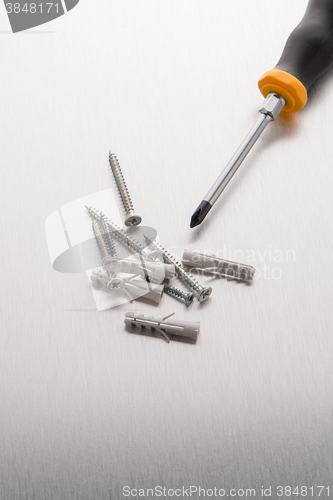 Image of Screwdriver, screws and plastic dowels