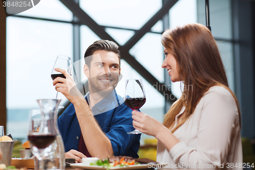 Image of couple dining and drinking wine at restaurant