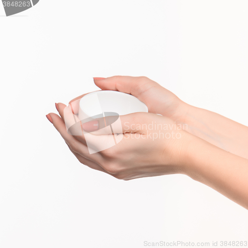 Image of Woman hand with cup on white background