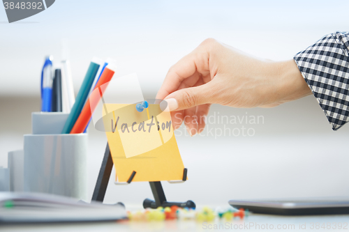 Image of Vacation text on adhesive note