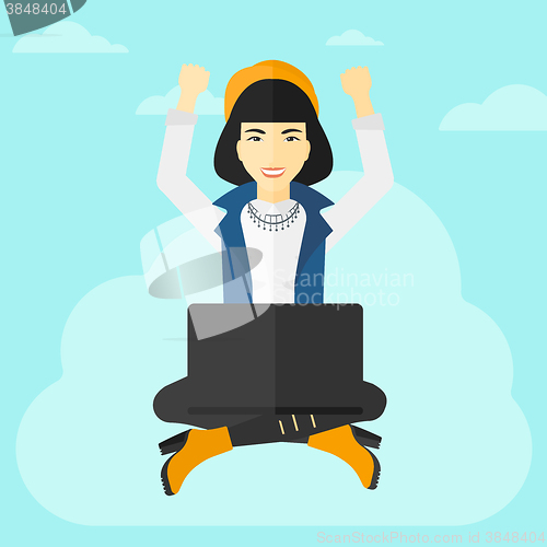 Image of Woman sitting on cloud with laptop.