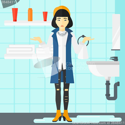 Image of Woman in despair standing near leaking sink.