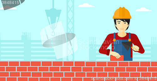 Image of Bricklayer with spatula and brick.