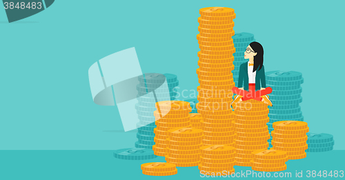 Image of Business woman sitting on gold.