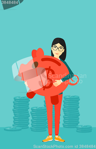 Image of Woman carrying piggy bank.