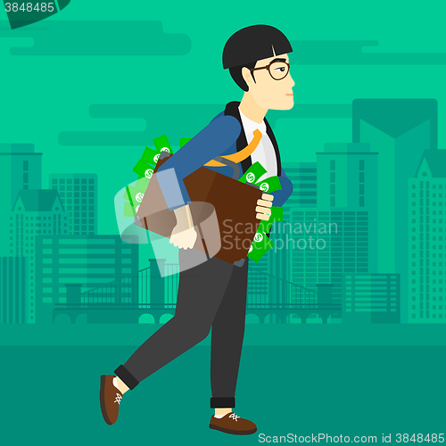 Image of Man with suitcase full of money.