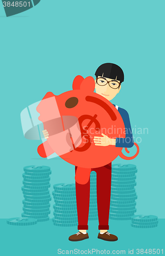 Image of Man carrying piggy bank.