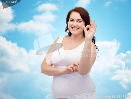 Image of plus size woman in underwear showing ok hand sign