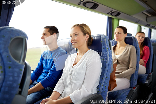 Image of group of happy passengers in travel bus