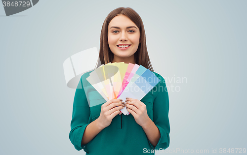 Image of smiling young woman with color swatches