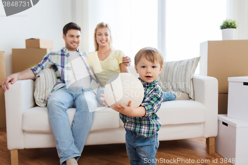 Image of happy little boy with ball over parents at home