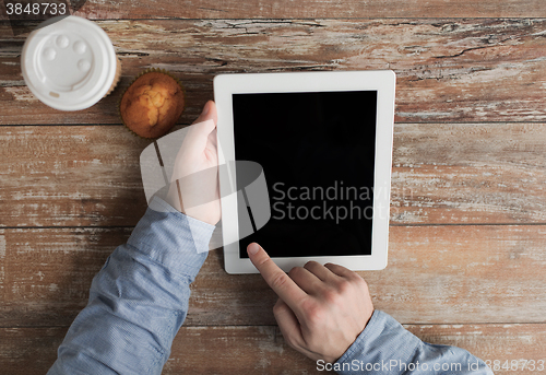 Image of close up of male hands with tablet pc and coffee