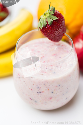 Image of close up of glass with milk shake and fruits