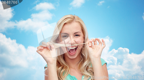 Image of happy young woman making mustache with her hair