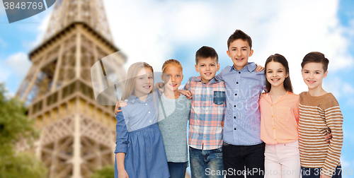 Image of happy smiling children hugging over eiffel tower