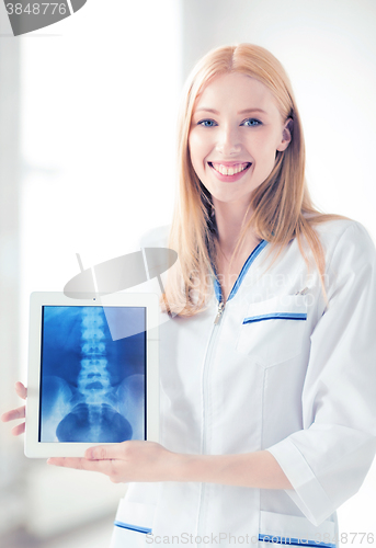 Image of female doctor with x-ray on tablet pc