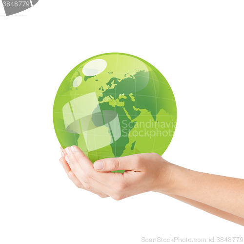 Image of close up of woman holding green globe in her hands