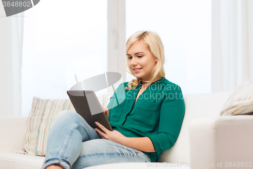 Image of smiling woman with tablet pc at home