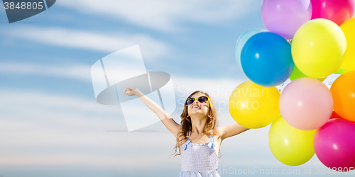 Image of happy girl with colorful balloons