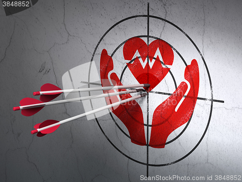 Image of Insurance concept: arrows in Heart And Palm target on wall background